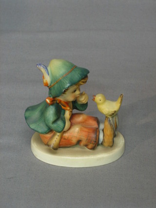 A Goebel figure of a seated boy listening to a bird 3" (chip to hat)
