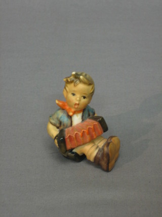 A Goebel figure of a seated boy playing an accordion 3"