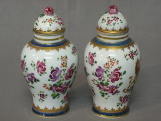 A pair of 19th Century Sampson porcelain urns and covers with Oriental style floral and armorial decoration 6"