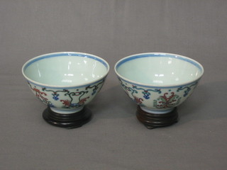 A pair of Oriental circular teabowls with floral decoration, the base with 6 character mark 4"