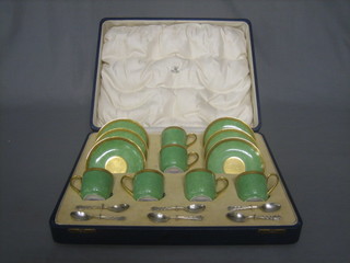 A 6 piece Limoges coffee service with green and gilt banding with 6 cups and 6 saucers (1 saucer and 1 cup cracked) together with 6 coffee spoons by Maple & Co, contained in a fitted case