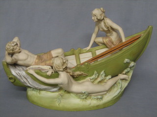 A Royal Dux figure in the form of a rowing boat with reclining gentleman and 2 lady swimmers, the base with pink triangular Royal Dux mark, marked E and impressed 1329 together with a pair of replacement wooden oars 20" (this figure was presented by the Cadbury family to a nurse who looked after one of their sons prior to WWII and who bequeathed it to the current owners family)