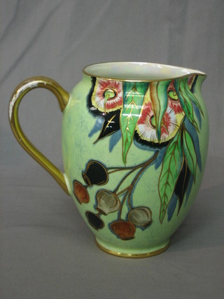 A Carltonware green glazed pottery jug with floral decoration and gilt handle 7"