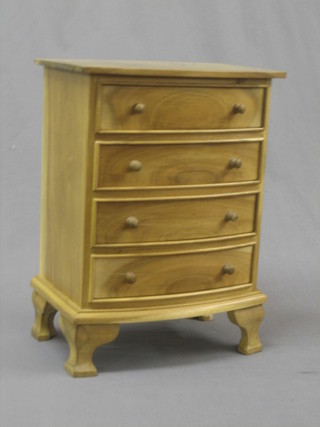 A bleached mahogany apprentice style chest of 4 long drawers with tore handles, raised on ogee bracket feet 12"