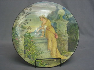 A circular terracotta charger decorated a figure of a lady on a terrace, painted by K Edwards 15"
