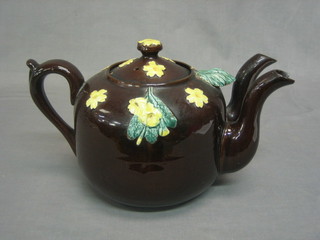 A 19th/20th Century circular Bargeware style twin spouted teapot with floral decoration (1 spout chipped)