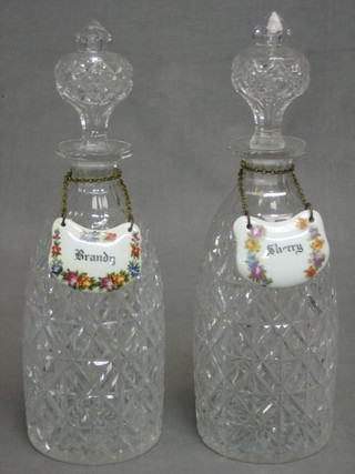 A pair of cut glass club shaped decanters with stoppers and porcelain decanter labels 11"