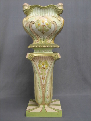 An Art Nouveau square pottery jardiniere decorated flowers 12" raised on a tapered base (f and r)