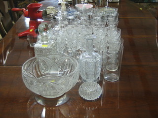 A square cut glass spirit decanter and stopper, a club shaped decanter, a circular cut glass pedestal bowl, a small collection of decorative china, a red enamelled mincer  and a suite of various drinking glasses