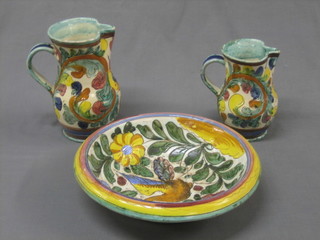 An Italian circular pottery bowl decorated a bird 12", together with 2 pottery jugs 8" and 7"