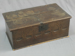 An 18th Century carved oak bible box with hinged lid and carved panelled decoration to the front and with iron hinge and lock 28"
