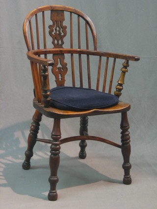 An 18th/19th Century elm and yew Windsor chair with stick and slat back and cow horn stretcher, raised on turned supports