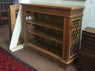 A Georgian style bleached mahogany bookcase with adjustable shelves and fret work decoration to the sides, raised on a platform base 42" 