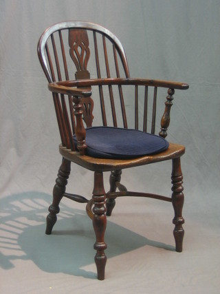An 18th/19th Century elm and yew Windsor carver chair with pierced vase shaped slat back, raised on turned supports with cow horn stretcher (spindle to left hand side cracked)