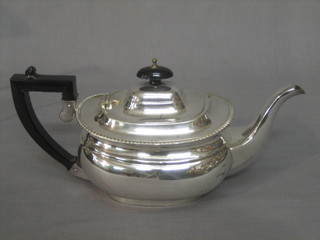 A Georgian style oval silver plated teapot with gadrooned decoration