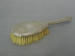 An Art Deco silver backed hairbrush with engine turned decoration