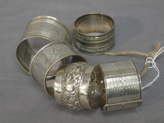 A Victorian silver buckle shaped napkin ring, 1 other silver napkin ring and an Eastern silver napkin ring, and 2 other napkin rings 3 ozs