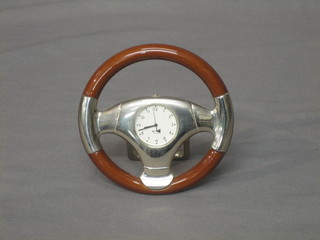 A novelty desk clock with quartz movement in the form of a car steering wheel