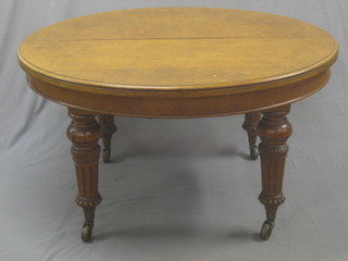 A Victorian light oak oval extending Campaign dining table, raised on 4 turned and fluted supports with 2 extra leaves 54"