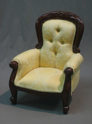A miniature Victorian style childs mahogany show frame armchair upholstered in yellow material, raised on cabriole supports