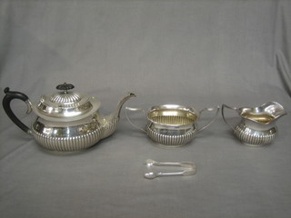 An oval silver plated 3 piece tea service with demi-reeded decoration comprising teapot, cream jug and sugar bowl