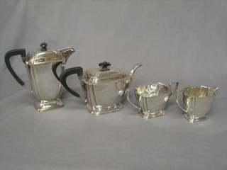 An Art Deco style silver plated 4 piece tea service comprising teapot, hotwater jug, sugar bowl and milk jug