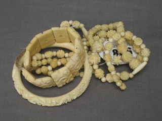 2 ivory bangles, 2 strings of ivory beads and a pair of ivory ear studs