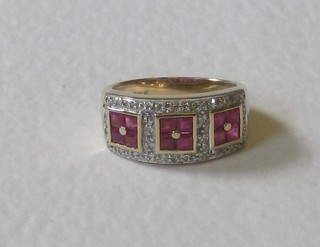 A 9ct gold dress ring set a square cut ruby supported by diamonds