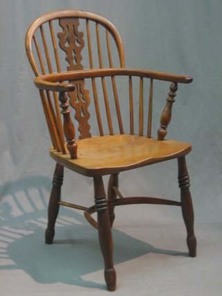 An 18th/19th Century elm and yew Windsor chair with vase shaped slat back and cow horn stretcher, raised on turned supports (somewhat wobbly)