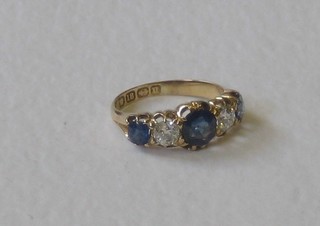 A lady's 18ct gold dress ring set 2 large oval cut sapphires supported by 2 diamonds