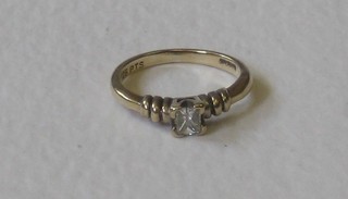 A lady's gold dress ring set a  Princess cut diamond