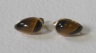A pair of gold set Tigers Eye tear drop shaped earrings
