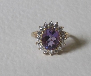 A gold dress ring set a large oval cut amethyst supported by numerous diamonds