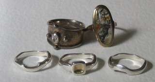 A heavy silver ring, a silver ring in 3 sections and a gold ring