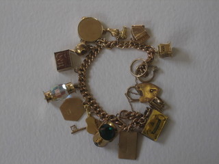 A 9ct gold curb link charm bracelet hung numerous charms