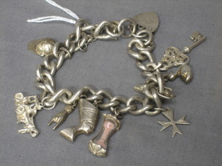 A silver curb link charm bracelet hung various charms
