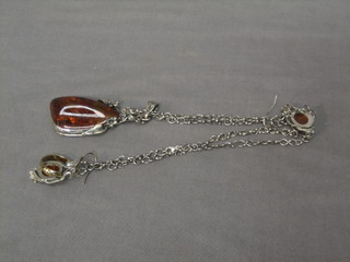 An "amber" pendant and a pair of "amber" earrings