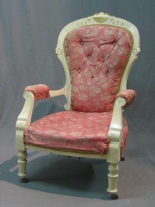 A Victorian white painted walnut open arm armchair upholstered in pink and white material, raised on turned supports
