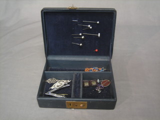A jewellery box containing a small collection of costume jewellery