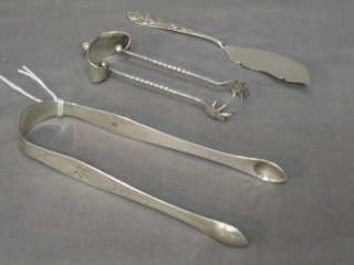 A pair of Georgian silver bright cut sugar tongs, 1 other pair of tongs and a silver butter knife, 2 ozs 