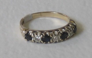 A 9ct yellow gold dress ring set 4 sapphires interspaced by diamonds, (sapphires approx 0.40ct)