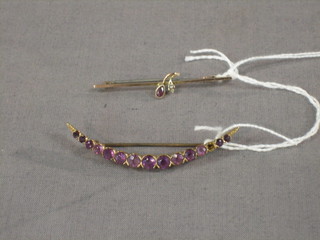 A gold bar brooch and a crescent shaped gilt metal bar brooch set pink stones