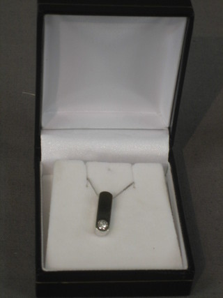 A gold pendant set a white stone