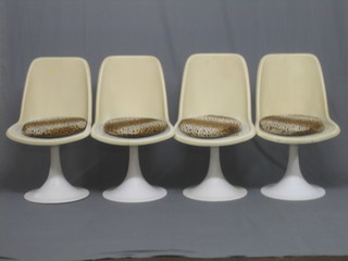 A set of 4 French white plastic 1960's revolving chairs