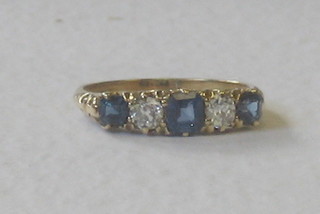 A lady's gold dress ring set 3 sapphires supported by diamonds