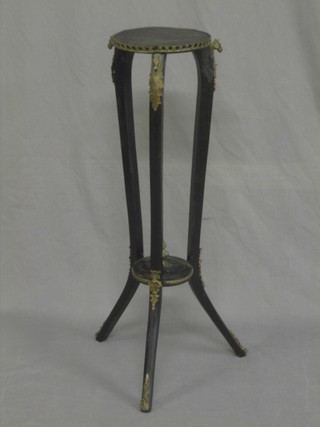 A circular ebonised and gilt banded jardiniere stand, raised on outswept supports 32"