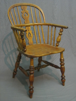 A 19th Century bleached elm stick back Windsor arm chair with vase shaped slat back, solid seat, raised on turned supports