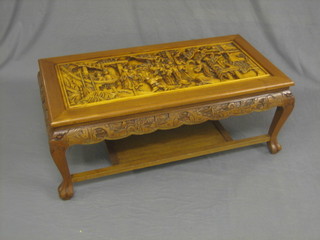 An Eastern rectangular carved hardwood coffee table  decorated court figures, raised on cabriole supports 40"