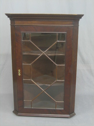 A Georgian style mahogany hanging corner cabinet with moulded and dentil cornice, the interior fitted adjustable shelves enclosed by astragal glazed panelled doors 28"