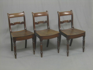 A set of 3 19th Century mahogany bar back dining chairs with shaped mid rails and solid saddle seats, raised on turned supports